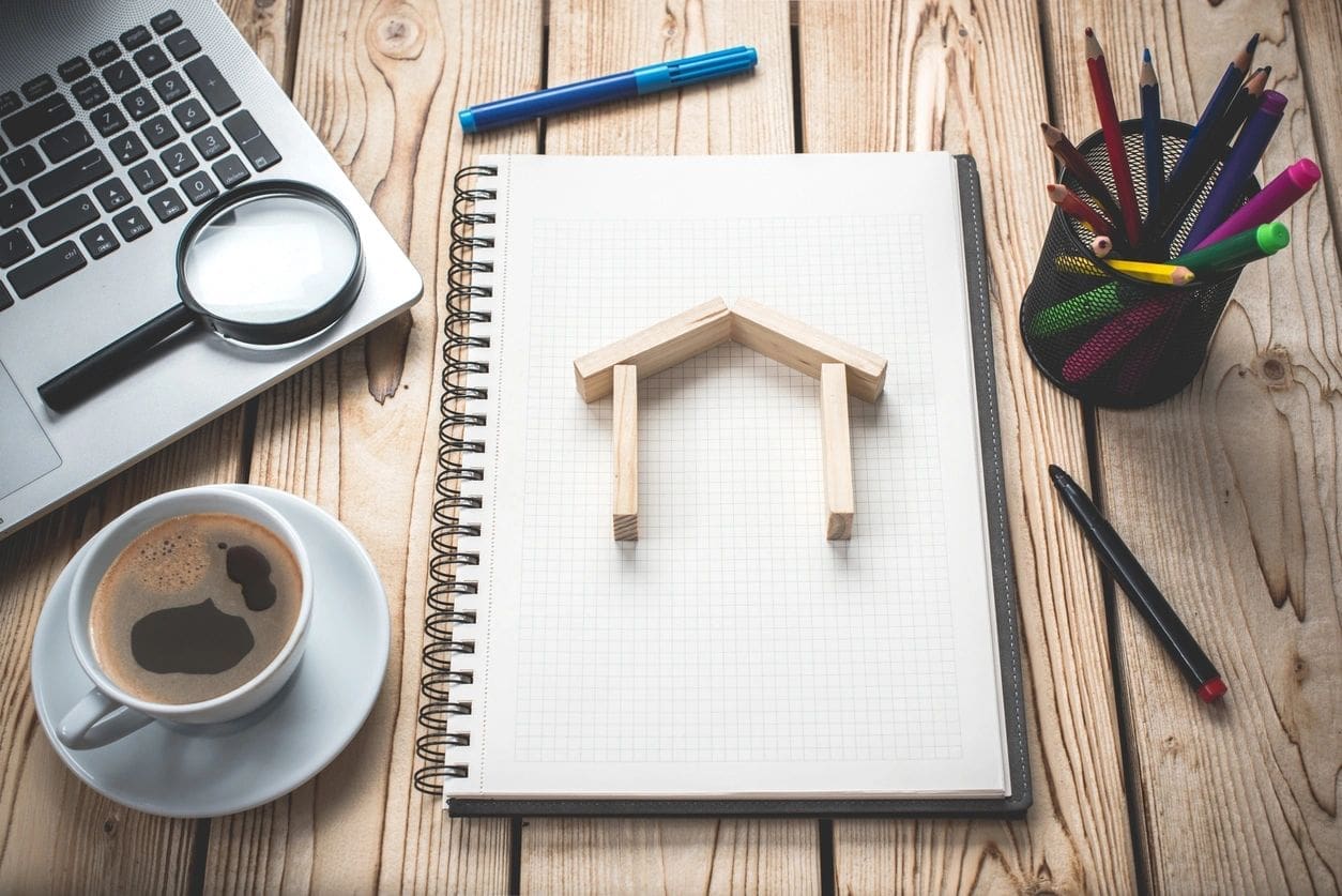 fm=f_xr2jr2q A notebook with a wooden house on top of it.
